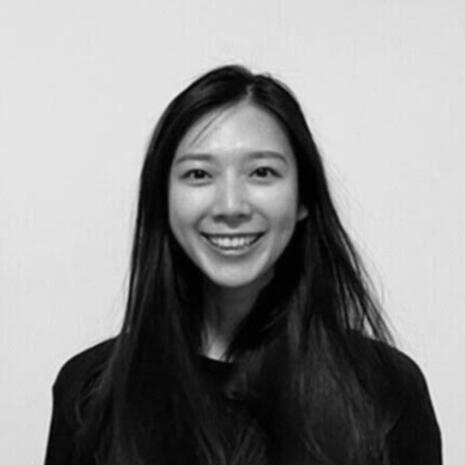 Portrait Portrait of Jennifer, a UX writer smiling at the camera.